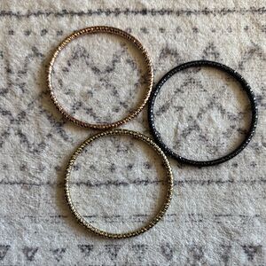 Elegant Trio of Gold, Silver, and Black Bangles